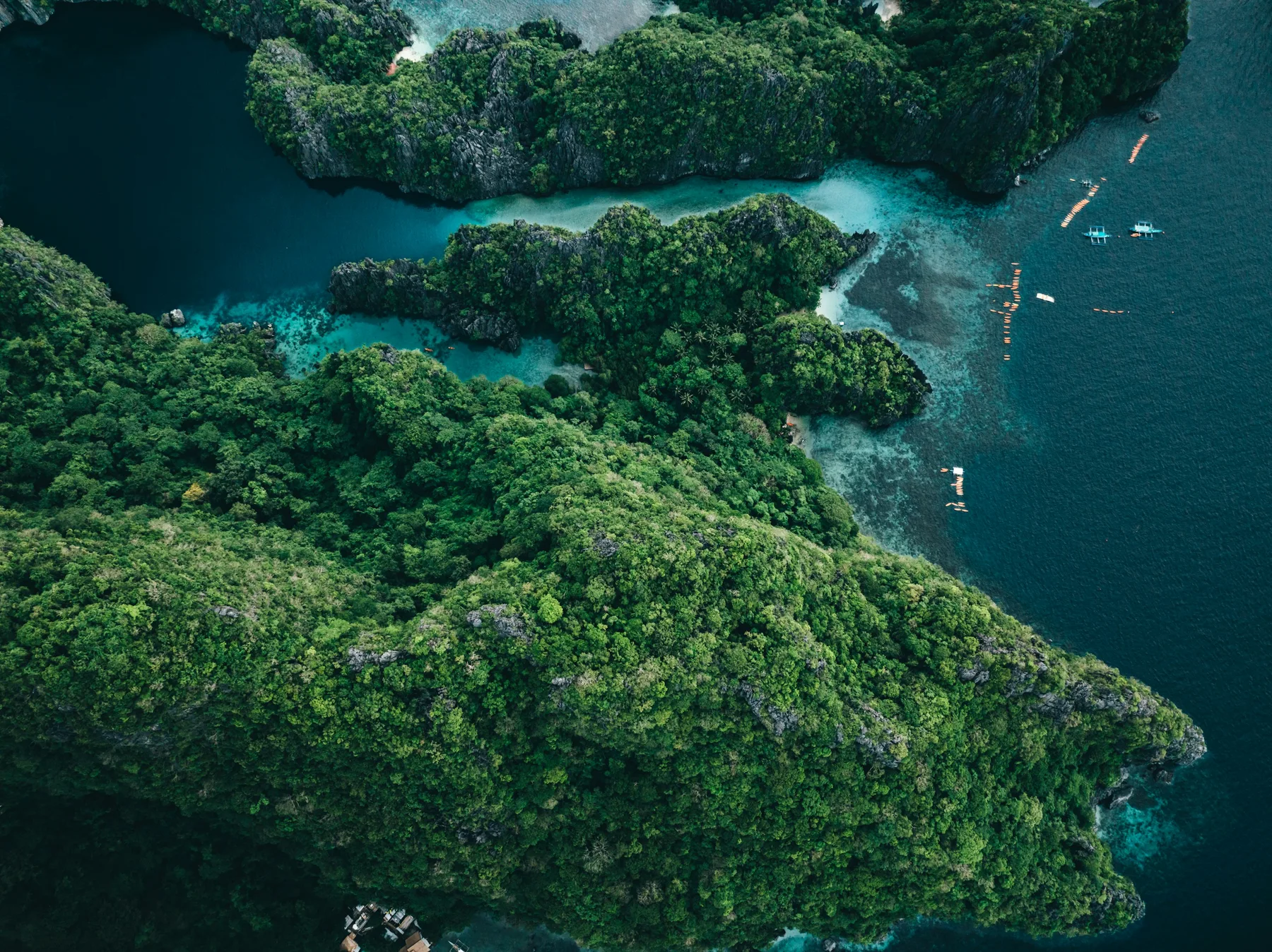 Aerial destination photograph of Big Lagoon and its jungle-covered limestone islands in El Nido